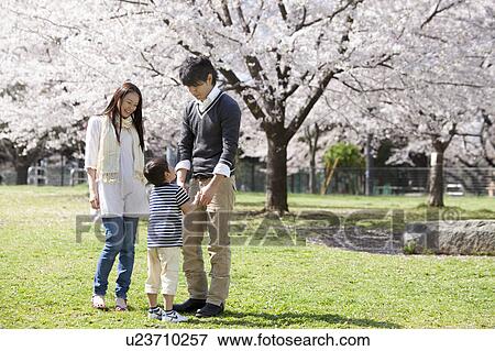 Stock Photo - Family of Three in Park. Fotosearch