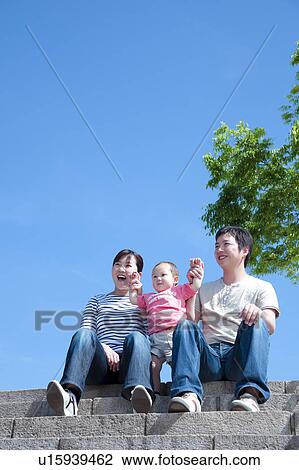 Stock Image - Family of Three on Steps. Fotosearch