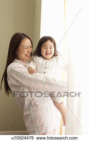 Stock Photo - Father and Daughter by Window. Fotosearch