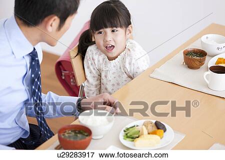 Stock Photo - Father and Daughter Having Breakfast. Fotosearch