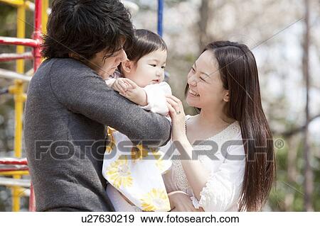 Father and Mother with Baby Girl View Large Photo Image Stock Photo - Father and Mother with Baby Girl. Fotosearch