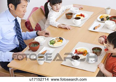 Father and Two Children Having Breakfast View Large Photo Image Picture - Father and Two Children Having Breakfast. Fotosearch
