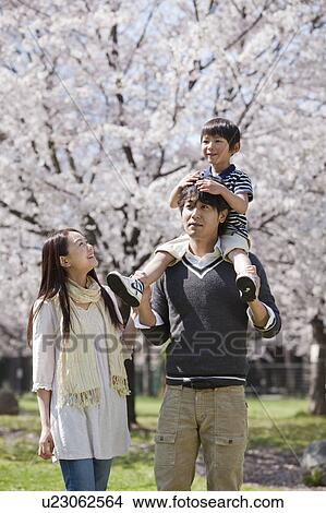 Father Carrying Son on Shoulders, Mother Beside View Large Photo Image Picture - Father Carrying Son on Shoulders, Mother Beside. Fotosearch