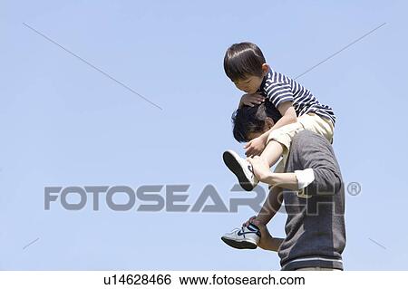Stock Photograph - Father Carrying Son on Shoulders. Fotosearch