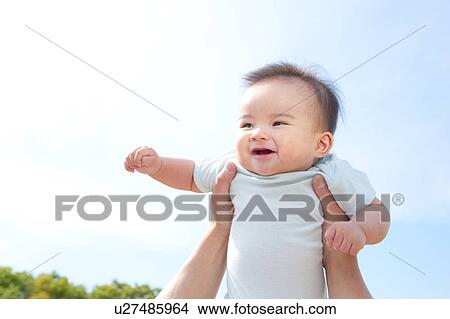 Father Holding Baby Boy Aloft View Large Photo Image Picture - Father Holding Baby Boy Aloft. Fotosearch