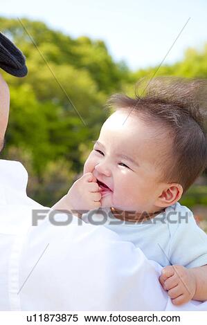 Stock Photography - Father Holding Baby Boy. Fotosearch