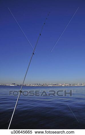 Stock Photography - Fishing rod and skyline of Tokyo, Koto ward, Tokyo Prefecture, Honshu, Japan. Fotosearch
