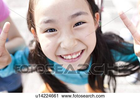 Stock Image - Girl Doing Peace Sign. Fotosearch