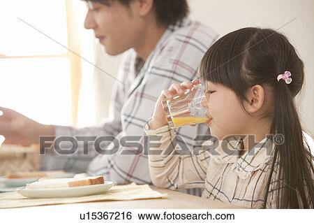Girl Drinkig Juice at Breakfast Table View Large Photo Image Stock Photograph - Girl Drinkig Juice at Breakfast Table. Fotosearch