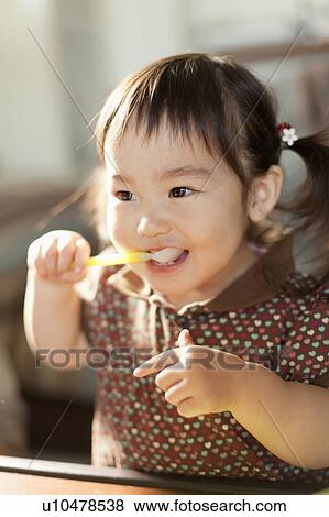 Stock Photo - Girl Eating. Fotosearch