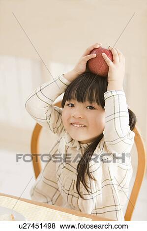 Girl Holding Apple on Her Head View Large Photo Image Stock Photo - Girl Holding Apple on Her Head. Fotosearch