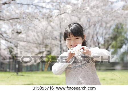 Stock Photograph - Girl Holding Cherry Blossoms. Fotosearch