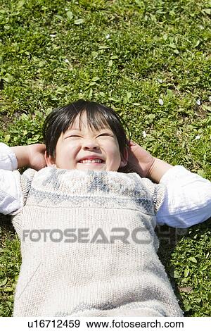 Girl Lying on Grass View Large Photo Image Stock Photo - Girl Lying on Grass. Fotosearch