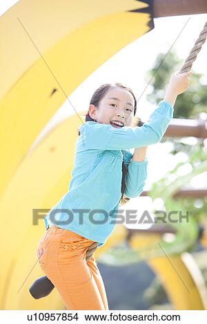 Picture - Girl Swinging with Rope. Fotosearch