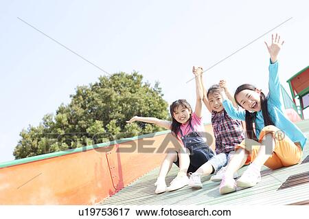 Stock Photo - Girls on Slide. Fotosearch
