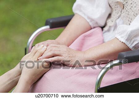 Healthcare worker and senior woman holding hands, Tokyo Prefecture, Honshu, Japan View Large Photo Image Stock Image - Healthcare worker and senior woman holding hands, Tokyo Prefecture, Honshu, Japan. Fotosearch