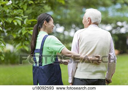 Healthcare worker helping senior man walk with cane, Tokyo Prefecture, Honshu, Japan View Large Photo Image Stock Image - Healthcare worker helping senior man walk with cane, Tokyo Prefecture, Honshu, Japan. Fotosearch