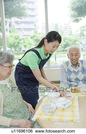 Healthcare worker serving food to senior people, Kanagawa Prefecture, Honshu, Japan View Large Photo Image Stock Photograph - Healthcare worker serving food to senior people, Kanagawa Prefecture, Honshu, Japan. Fotosearch