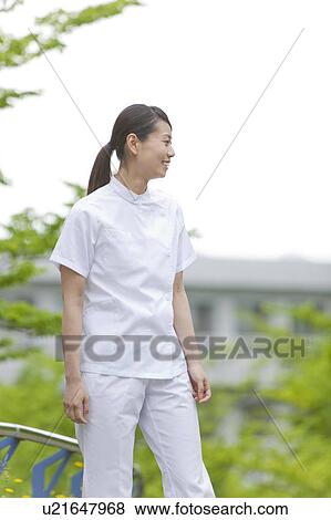 Healthcare worker standing in park, Kanagawa Prefecture, Honshu, Japan View Large Photo Image Stock Photo - Healthcare worker standing in park, Kanagawa Prefecture, Honshu, Japan. Fotosearch