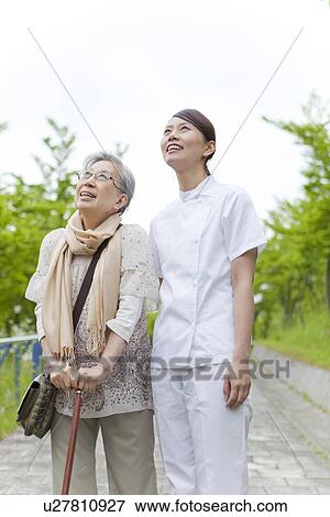 Healthcare worker with senior woman looking up, Kanagawa Prefecture, Honshu, Japan View Large Photo Image Stock Photo - Healthcare worker with senior woman looking up, Kanagawa Prefecture, Honshu, Japan. Fotosearch