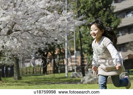 Japanese Girl Running in Park View Large Photo Image Stock Photo - Japanese Girl Running in Park. Fotosearch