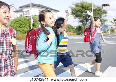 Stock Image - Kids crossing street, Japan. Fotosearch