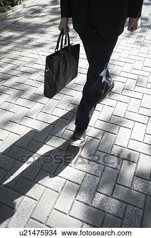 Low Section of Businessman Walking View Large Photo Image Picture - Low Section of Businessman Walking. Fotosearch