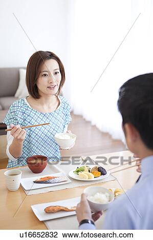 Stock Image - Mid Adult Couple Having Breakfast. Fotosearch