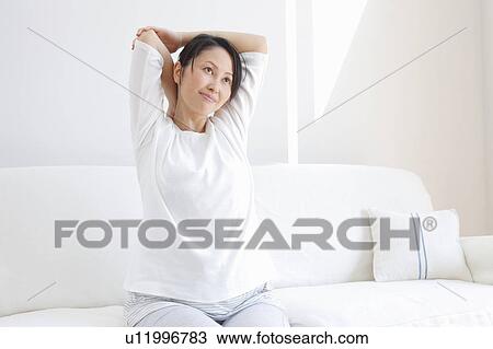 Mid Adult Woman Stretching on Sofa View Large Photo Image Stock Image - Mid Adult Woman Stretching on Sofa. Fotosearch