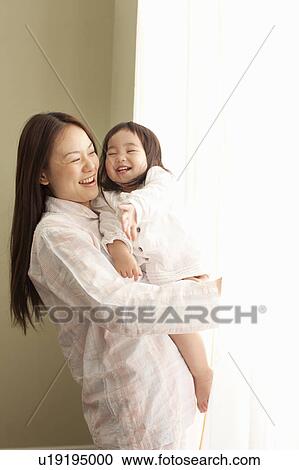 Stock Image - Mother and Daughter Looking Through Window. Fotosearch