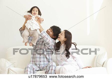 Mother and Father Holding Up Baby Girl View Large Photo Image Stock Image - Mother and Father Holding Up Baby Girl. Fotosearch