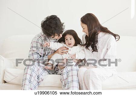 Mother and Father with Baby Girl on Sofa View Large Photo Image Stock Photography - Mother and Father with Baby Girl on Sofa. Fotosearch