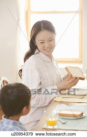 Stock Photo - Mother and Son at Breakfast table. Fotosearch