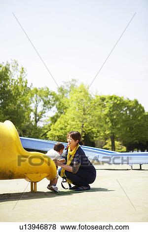Mother Catching Baby Boy on Slide View Large Photo Image Stock Photo - Mother Catching Baby Boy on Slide. Fotosearch