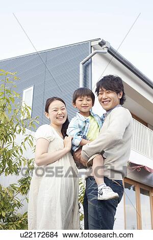 Picture - Mother, Father and Son Outside House. Fotosearch