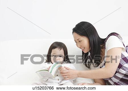Mother Helping Baby Girl with Picture Book View Large Photo Image Stock Photograph - Mother Helping Baby Girl with Picture Book. Fotosearch