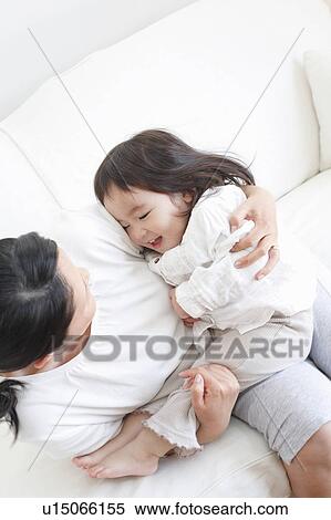Stock Photography - Mother Hugging Baby Girl. Fotosearch