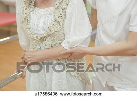 Nurse helping a senior woman walk, Kanagawa Prefecture, Honshu, Japan View Large Photo Image Stock Photograph - Nurse helping a senior woman walk, Kanagawa Prefecture, Honshu, Japan. Fotosearch