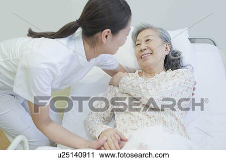 Nurse holding senior woman's hand, Kanagawa Prefecture, Honshu, Japan View Large Photo Image Stock Image - Nurse holding senior woman's hand, Kanagawa Prefecture, Honshu, Japan. Fotosearch