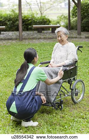 Stock Image - Nurse Talking to Senior Woman. Fotosearch