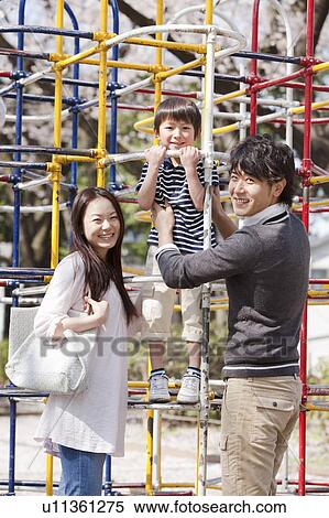 Stock Photography - Parents and Son in Playground. Fotosearch
