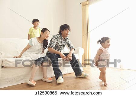 Stock Photography - Parents and Son Watching Baby Girl Walking. Fotosearch