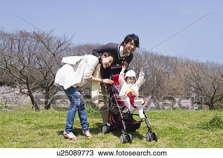 Parents Pushing Daughter in Buggy View Large Photo Image Stock Image - Parents Pushing Daughter in Buggy. Fotosearch