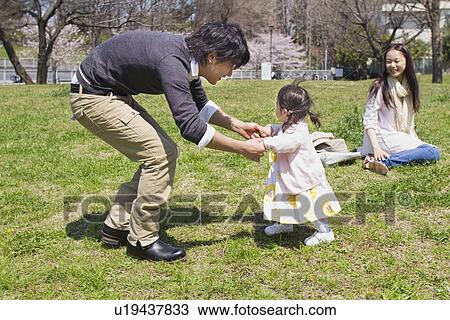 Parents with Baby Girl in Park View Large Photo Image Stock Image - Parents with Baby Girl in Park. Fotosearch