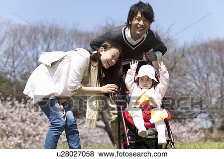 Parents with Baby Girl in Park View Large Photo Image Stock Photo - Parents with Baby Girl in Park. Fotosearch