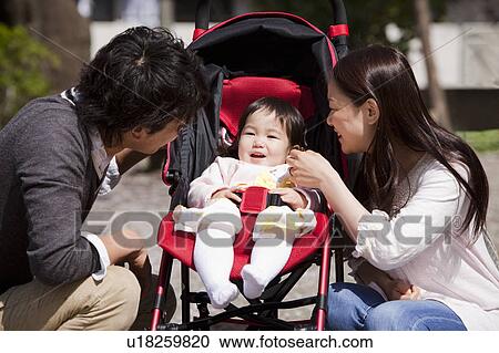 Stock Image - Parents with Baby Girl. Fotosearch