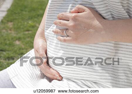 Pregant Woman Resting Hands on Stomach View Large Photo Image Stock Photo - Pregant Woman Resting Hands on Stomach. Fotosearch