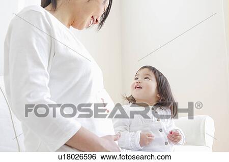 Stock Photograph - Pregnant Mother with Baby Girl. Fotosearch