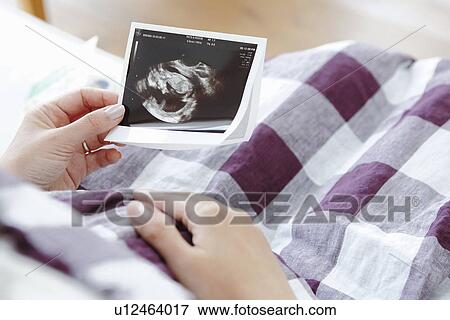 Pregnant Woman Holding Ultrasound Scan View Large Photo Image Stock Photo - Pregnant Woman Holding Ultrasound Scan. Fotosearch