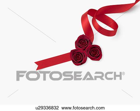 Stock Image - Red ribbon with flowers. Fotosearch